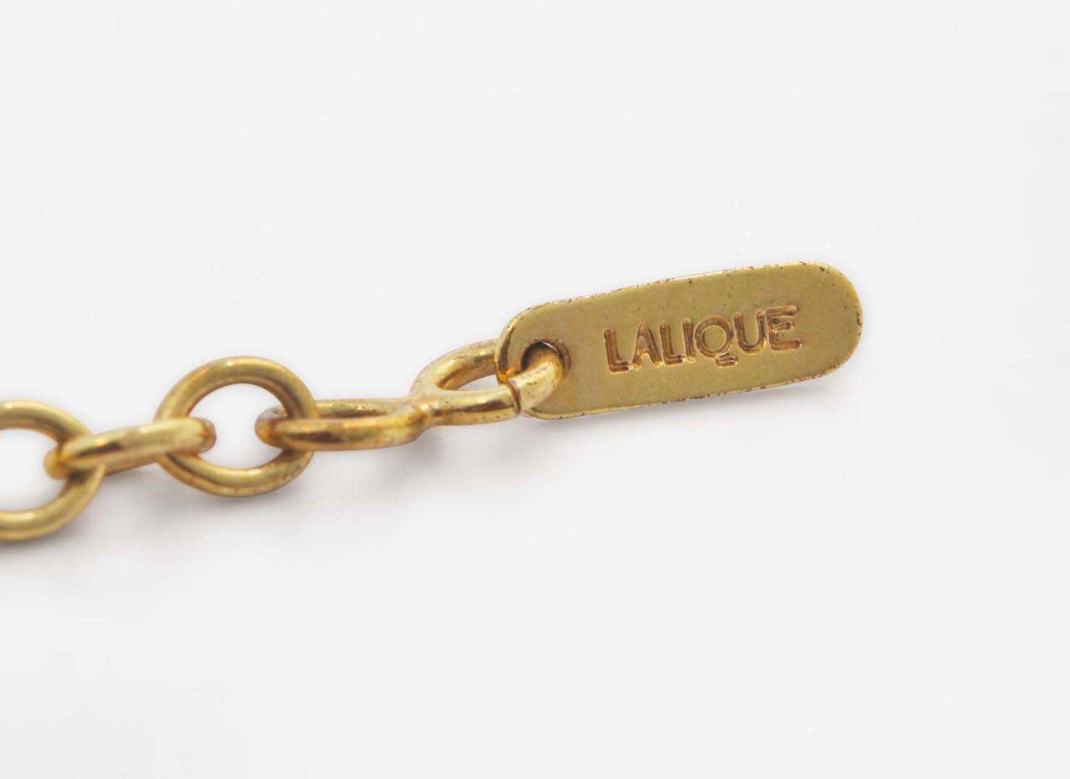 An 18K Yellow Gold and Diamond Pendant on a Lalique Cord
