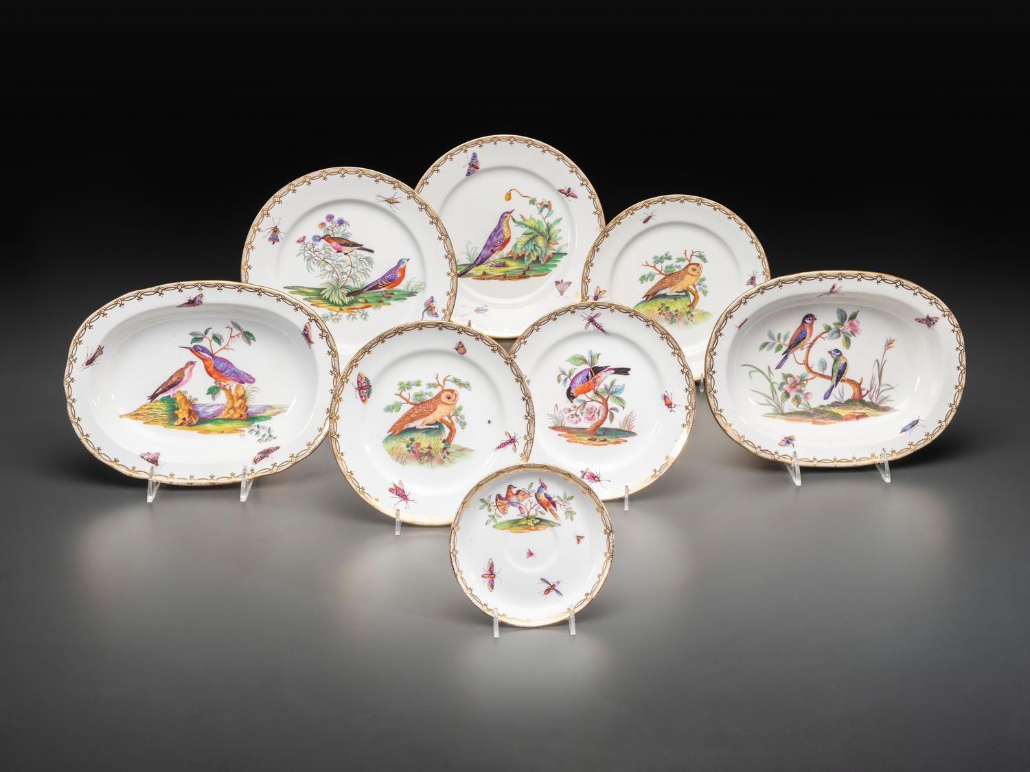 An English Parcel Gilt Bird and Insect Decorated Porcelain Partial Dinner Service