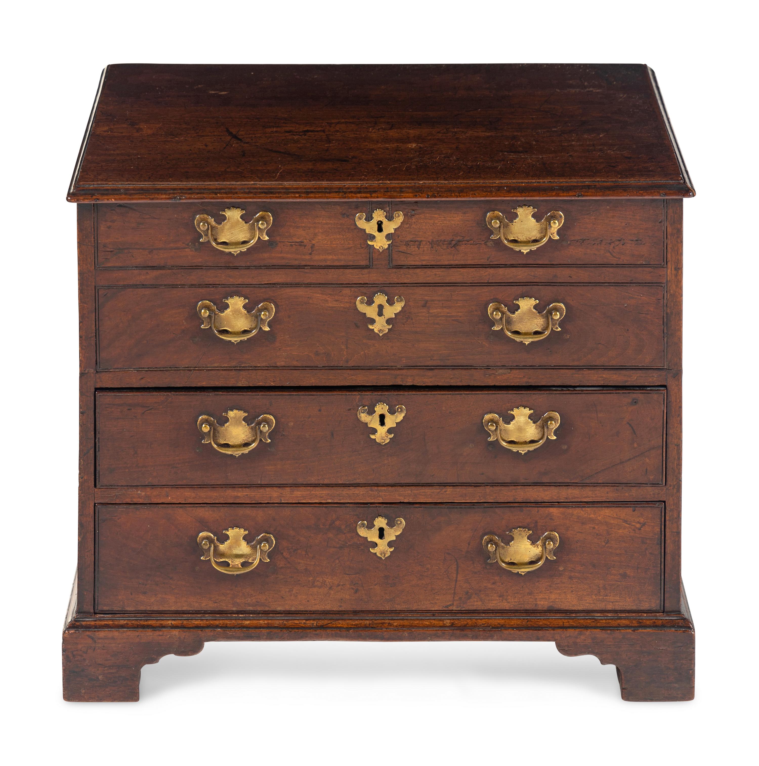 A George III Diminutive Lift-Top Chest of Drawers