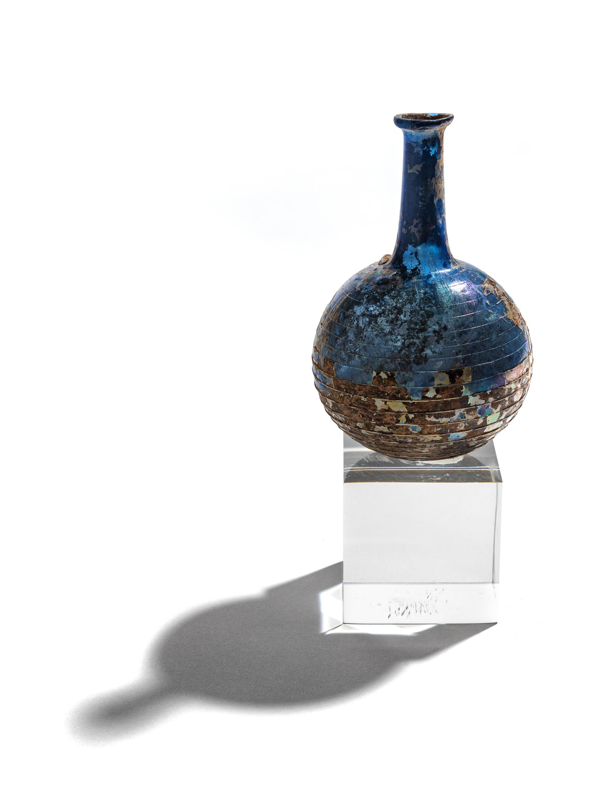A Roman Blue Glass Bottle with Spiral Trail