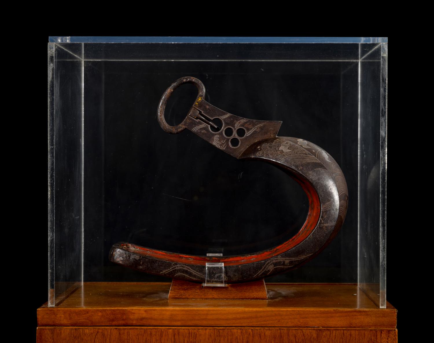 A Japanese Bronze Stirrup in a Walnut and Acrylic Pedestal Vitrine