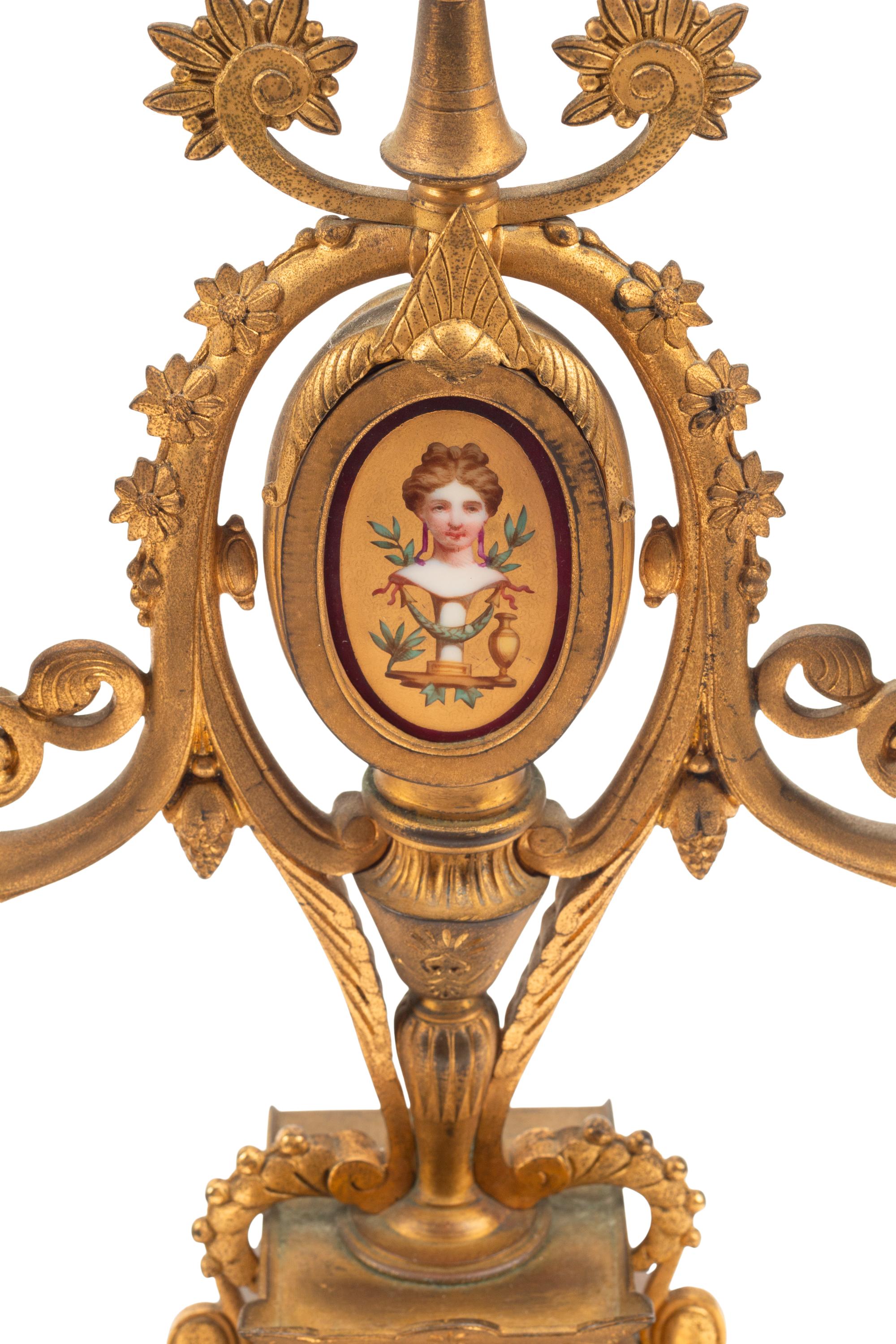 A French Neoclassical Gilt Bronze and Porcelain Plaque-Inset Clock Garniture
