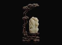 A Chinese white jade figural group with carved hardwood stand 白玉人物與木座