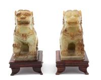 A Pair of Apple Green Jadeite Foo Lions Height 5 inches. — 20TH CENTURY