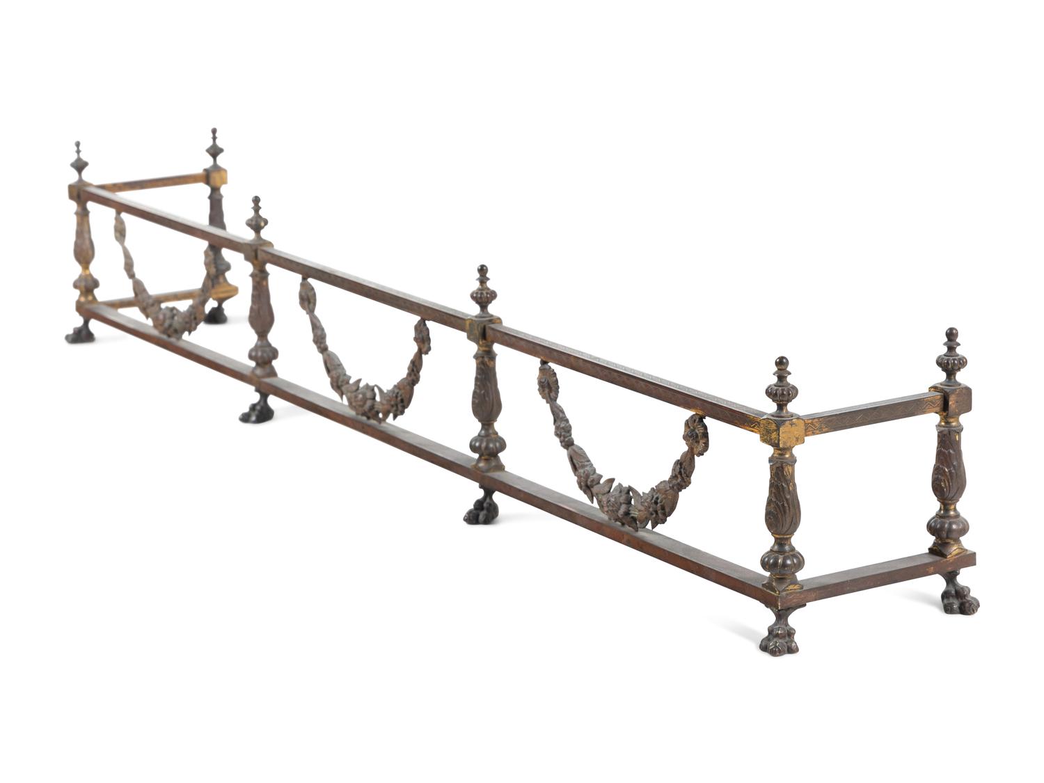 A Pair of Continental Brass and Iron Andirons and Fender