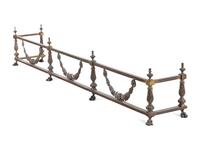 A Pair of Continental Brass and Iron Andirons and Fender