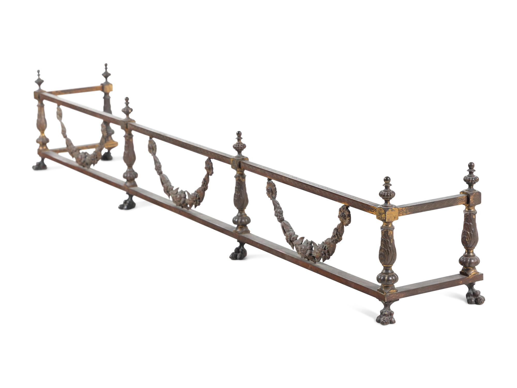 A Pair of Continental Brass and Iron Andirons and Fender