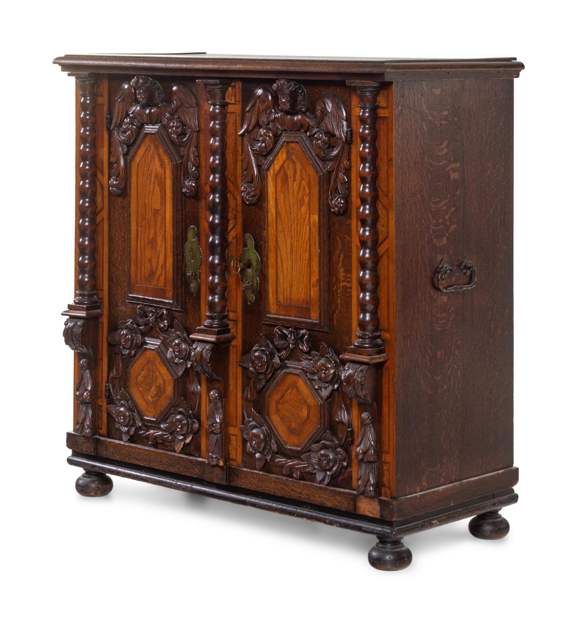 An Italian Baroque Carved Walnut and Oak Cabinet