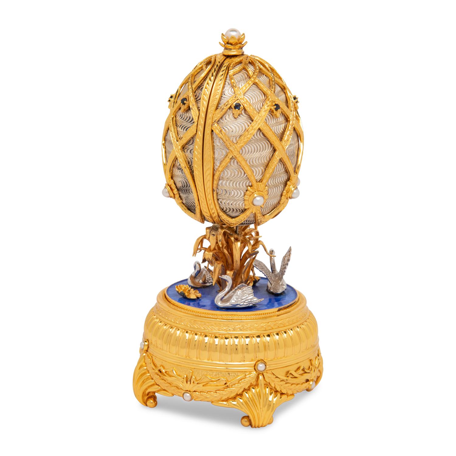 A Silver, Gilt and Enamel Decorated Swan Lake Egg-Form Music Box