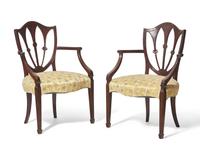 A pair of George III shield-back mahogany armchairs, late 18th / 19th century
