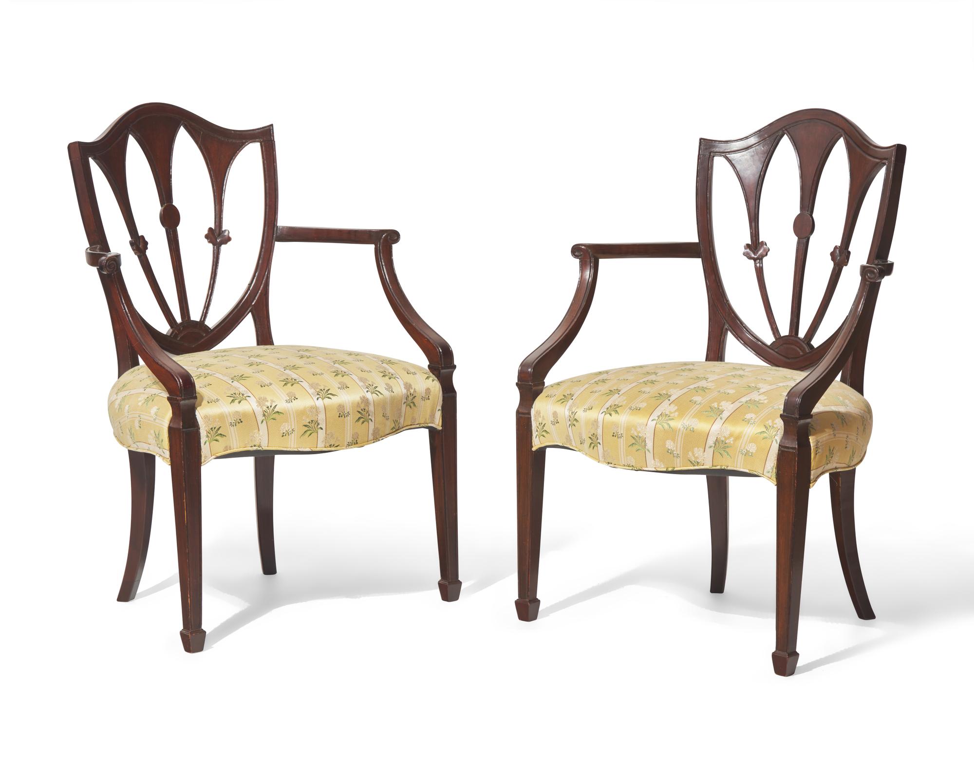 A pair of George III shield-back mahogany armchairs, late 18th / 19th century