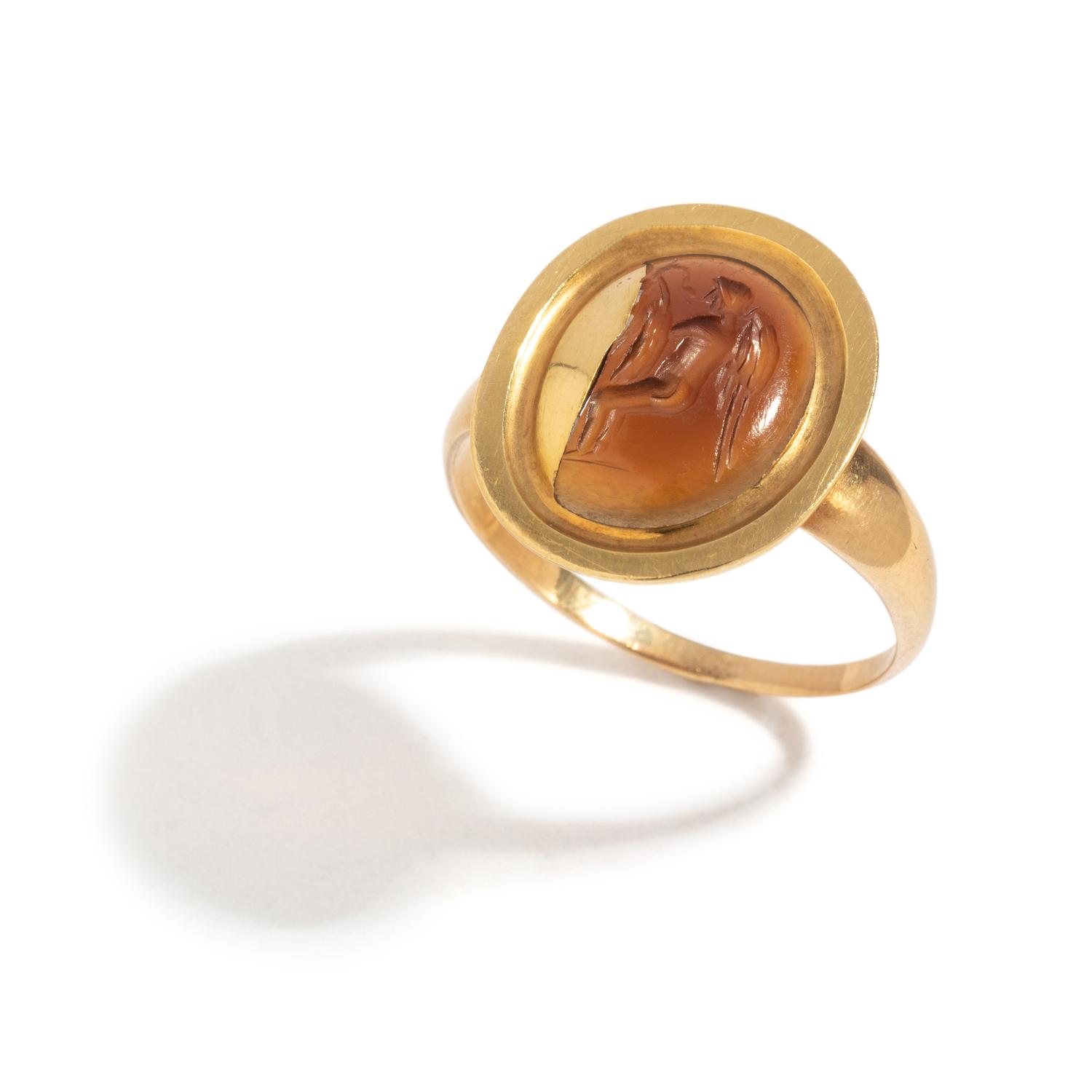 A Roman Carnelian Ring Stone with the God Eros Playing with a Swan — Set in a gold ring