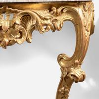 A pair of Louis XV carved giltwood consoles with breccia marble tops 18th century and possibly later