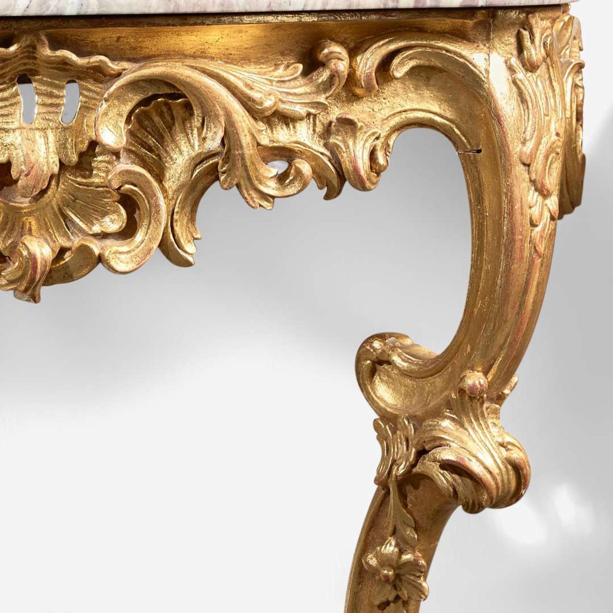 A pair of Louis XV carved giltwood consoles with breccia marble tops 18th century and possibly later