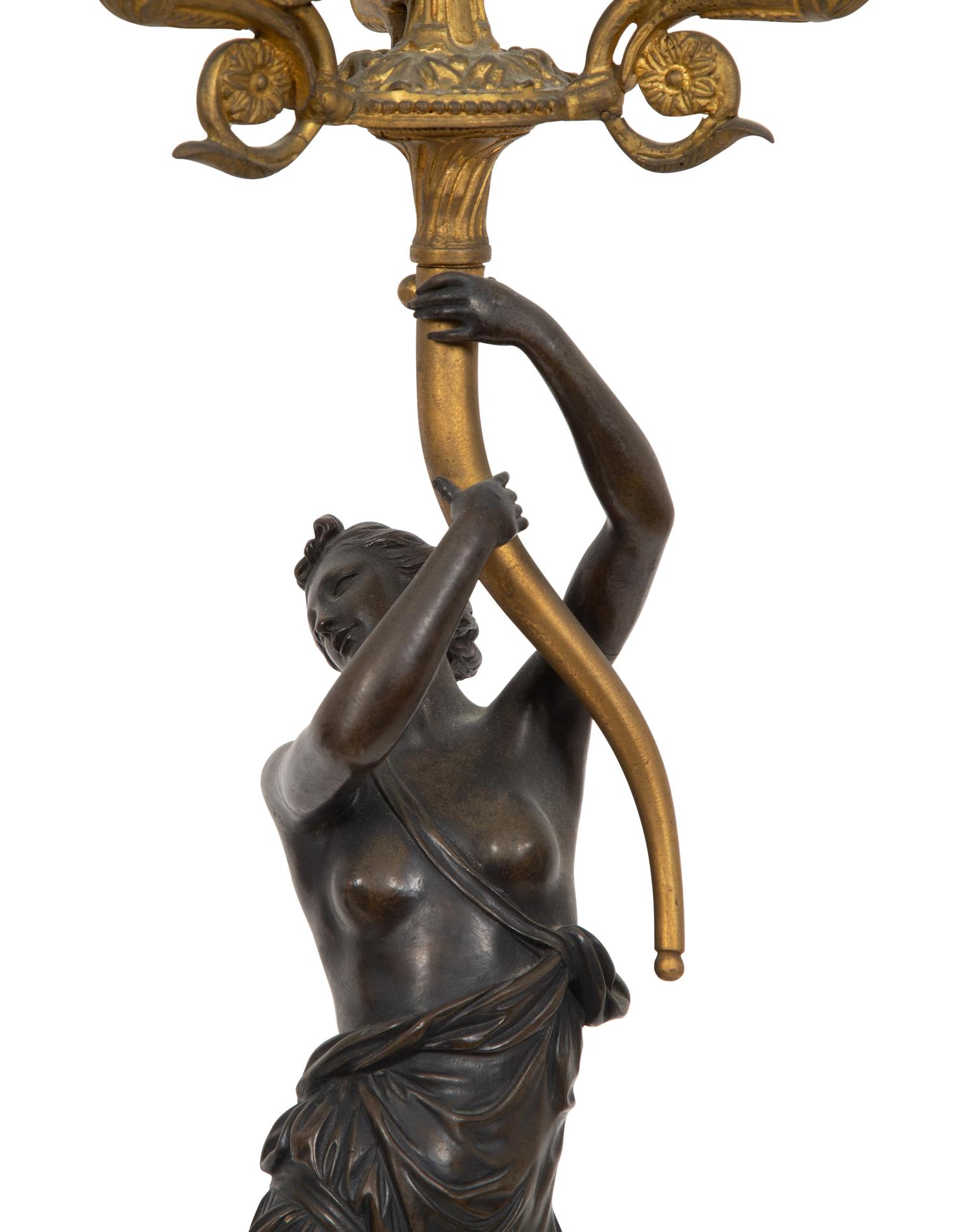 A Pair of French Empire Style Gilt and Patinated Bronze Figural Four-Light Candelabra