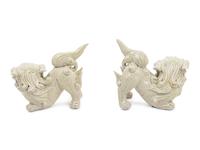A Pair of Chinese White Glazed Porcelain Figures of Fu Lions