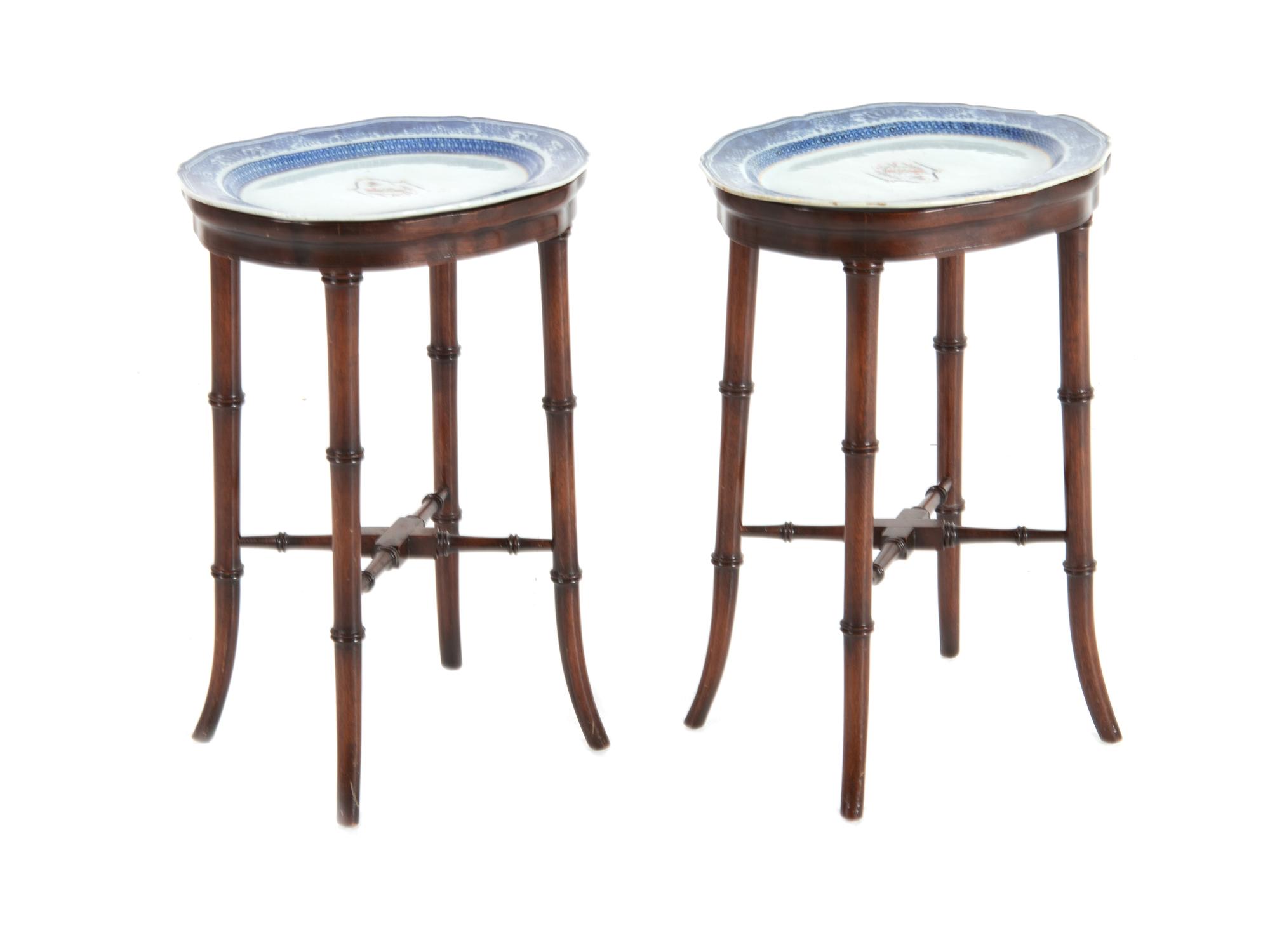 A Pair of Chinese Export Porcelain Armorial Platters Raised on Later Mahogany Stands