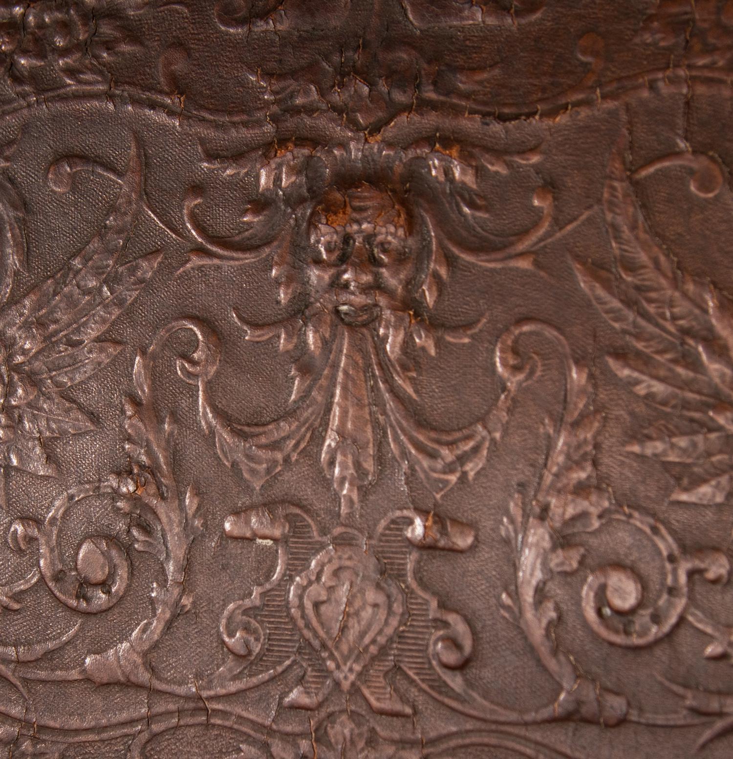 An Austrian Carved Walnut Bench with Tooled Leather Upholstery