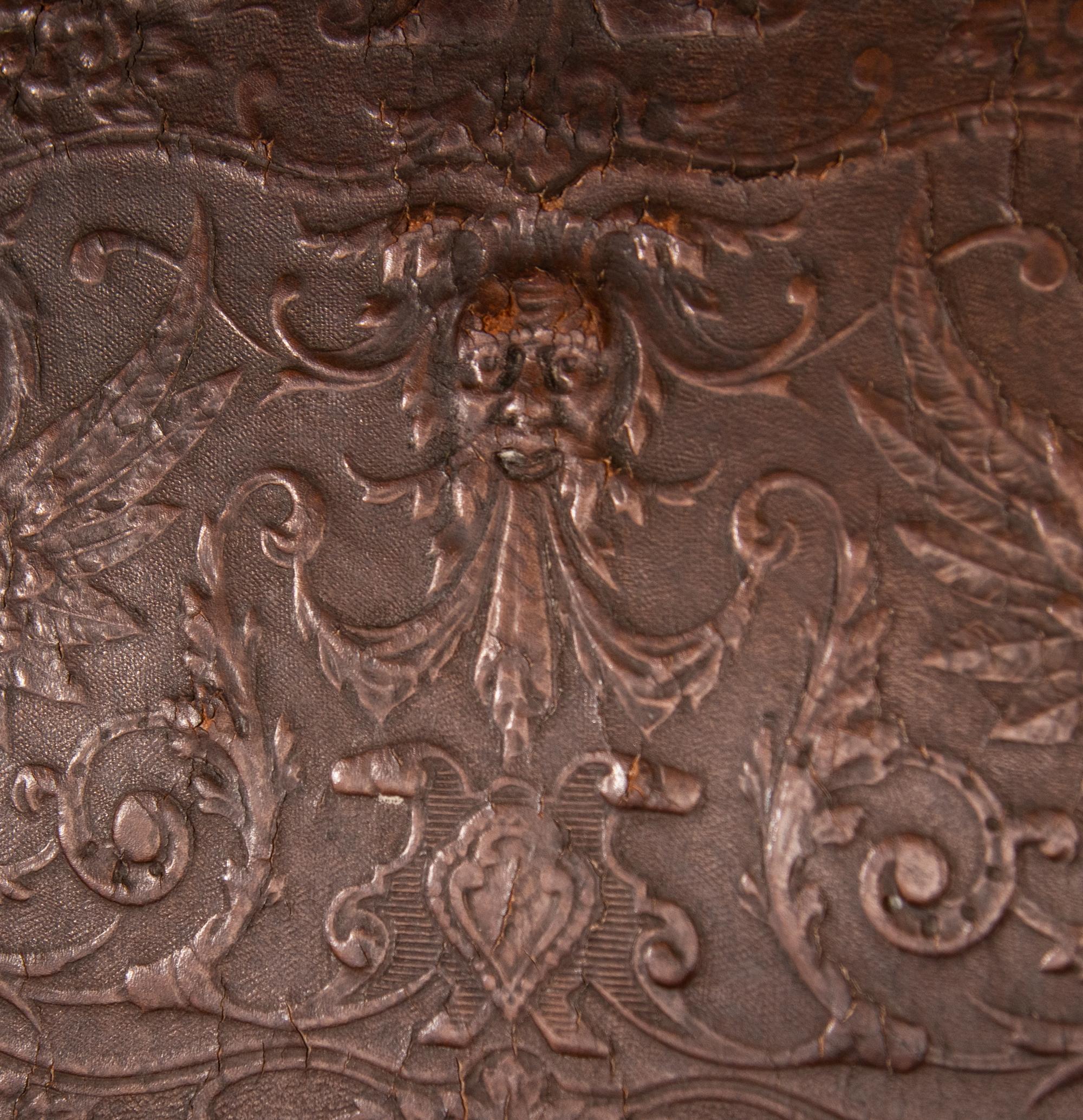 An Austrian Carved Walnut Bench with Tooled Leather Upholstery
