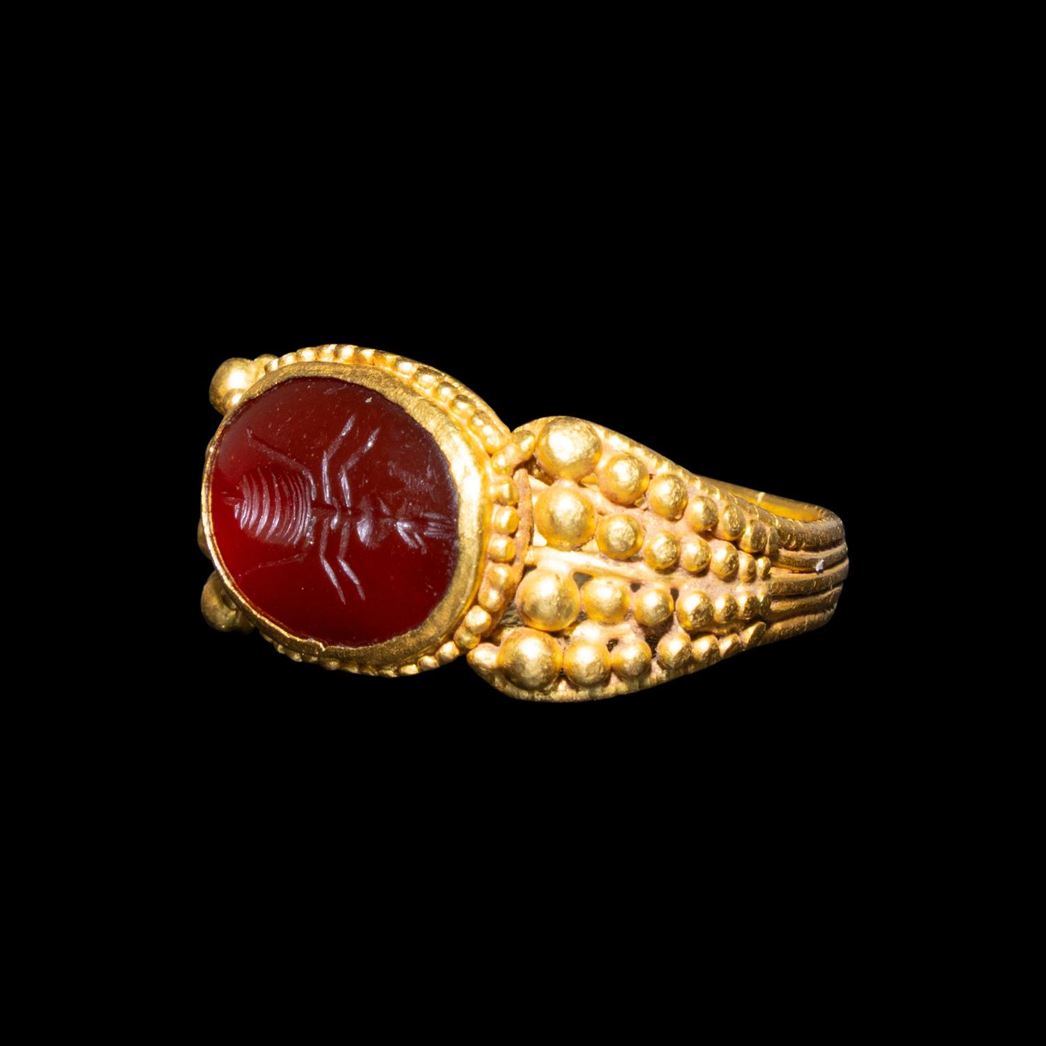 A Late Roman Gold and Carnelian Ring with an Ant Carrying an Ear of Wheat