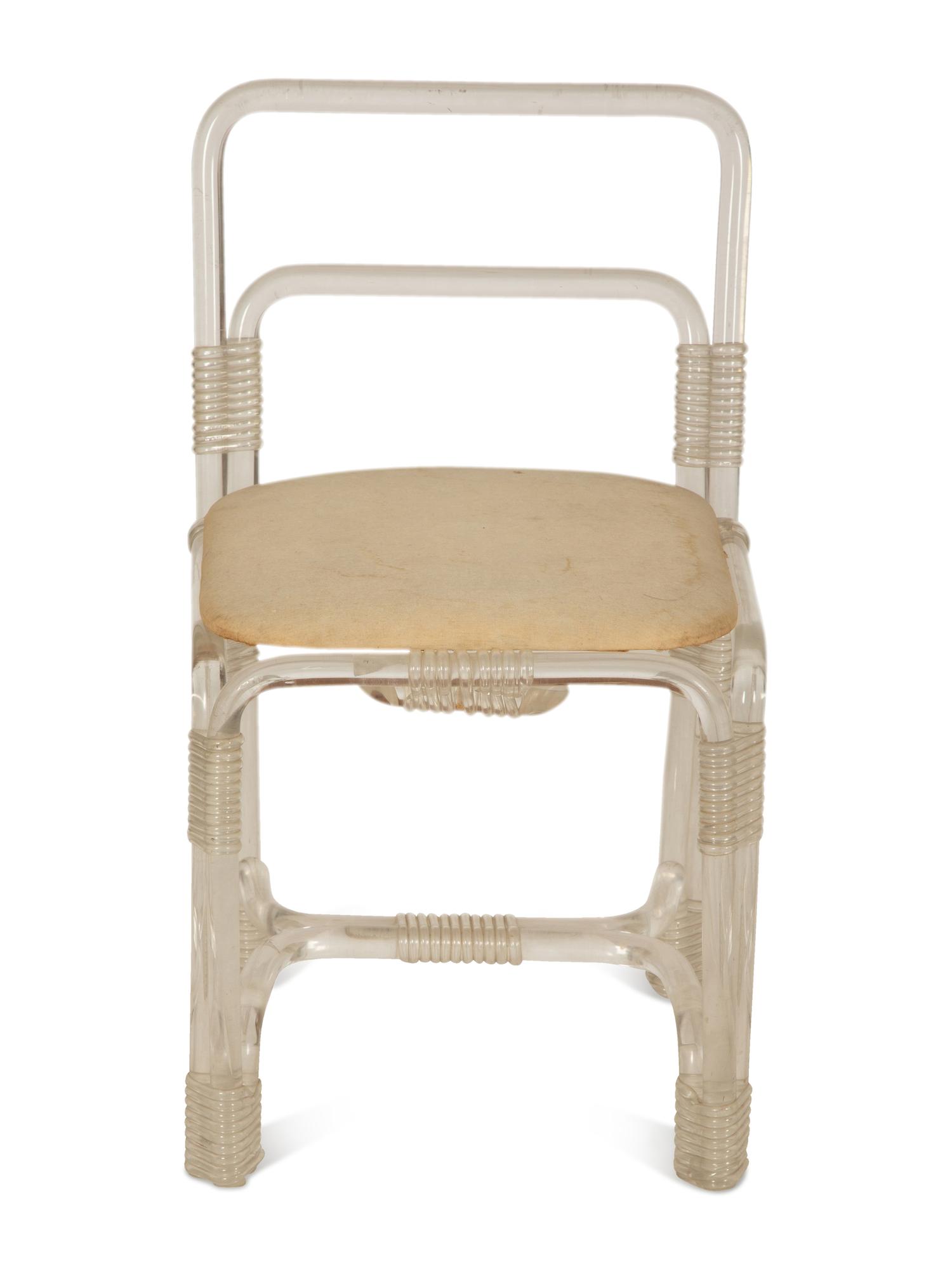 A Pair of Tubular Acrylic Low Back Chairs