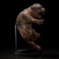 A carved and painted wood figure of a rampant feline 木雕大猫