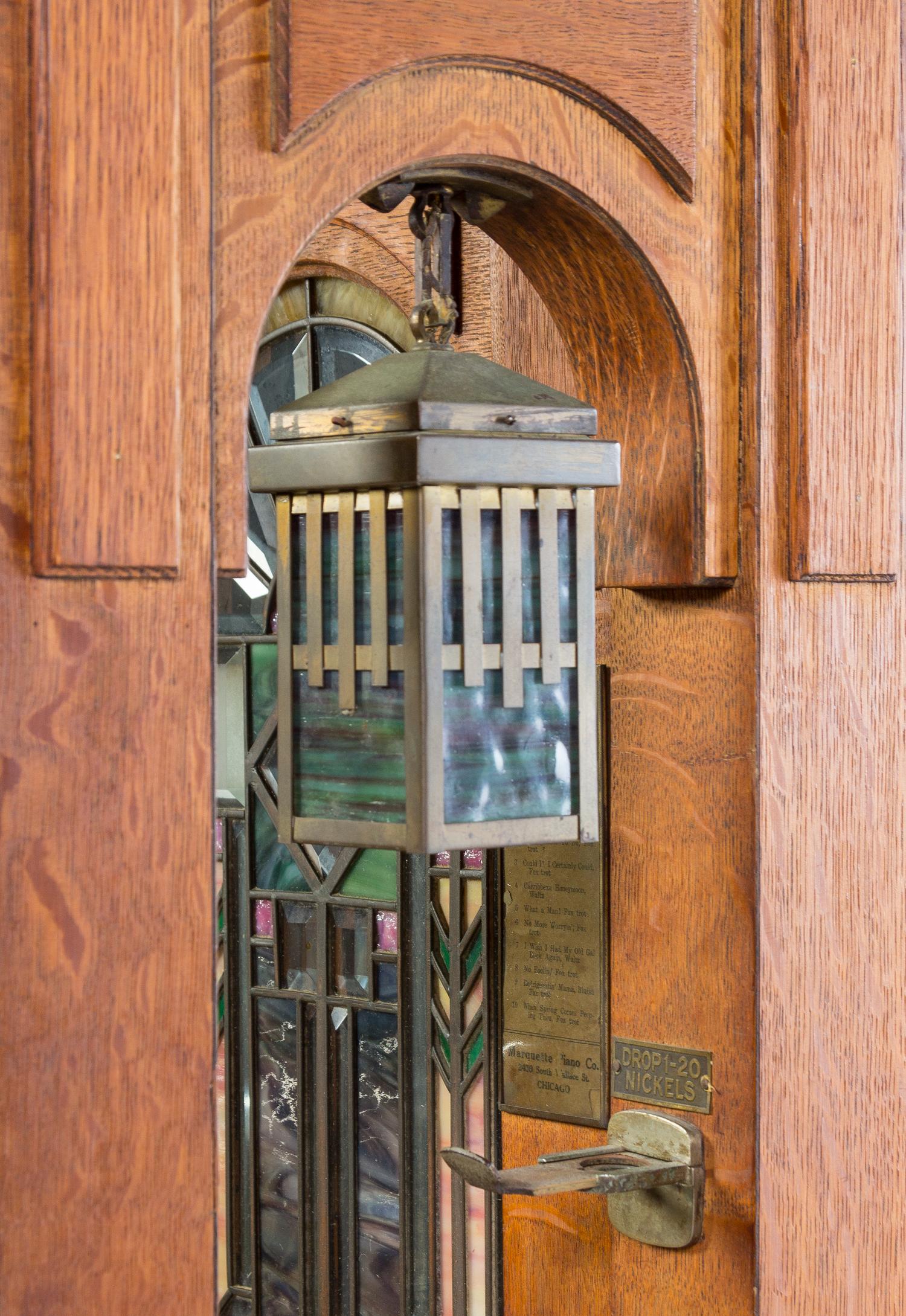 A Marquette Cremona Style K Oak and Stained Glass Orchestrion, CIRCA 1915, SERIAL NO. 11527, Height 66 x width 64 1/2 x depth 31 1/4 in — CIRCA 1915, SERIAL NO. 11527,