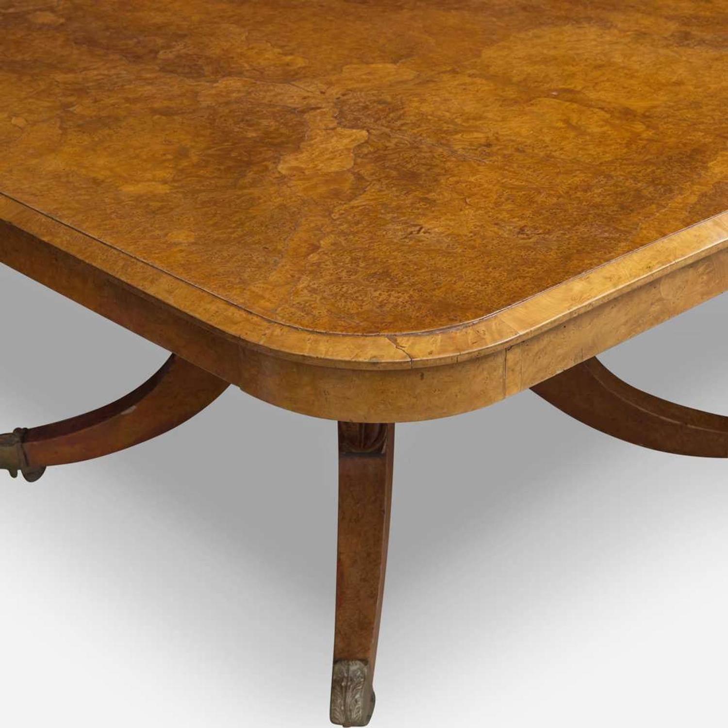 An impressive Regency pollard oak three-pedestal dining table circa 1820