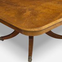 An impressive Regency pollard oak three-pedestal dining table circa 1820