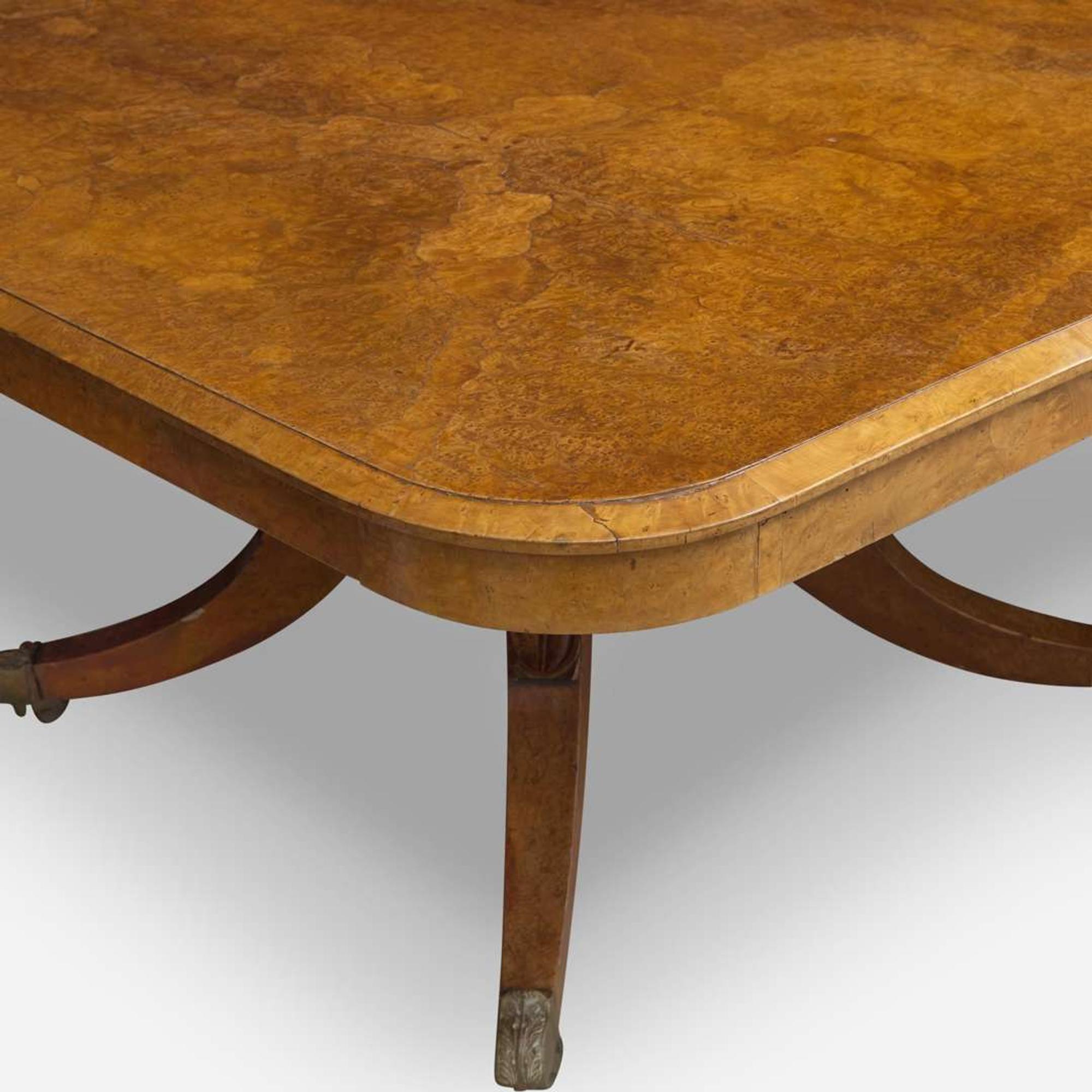 An impressive Regency pollard oak three-pedestal dining table circa 1820