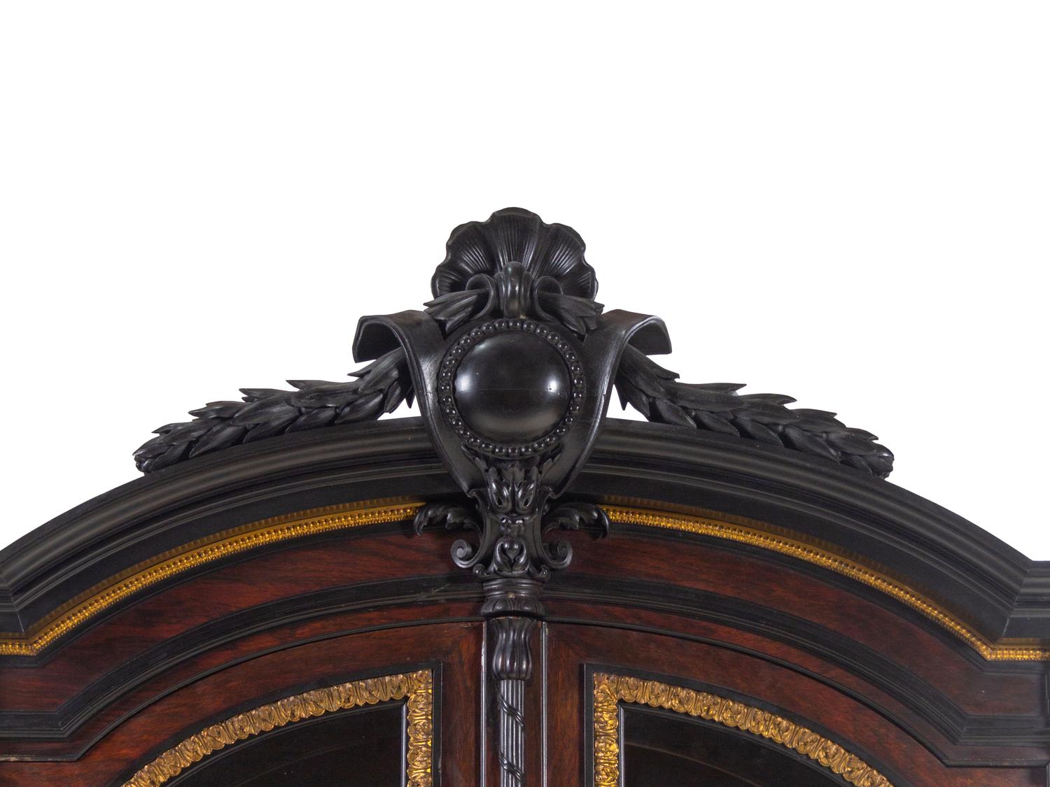 A Renaissance Revival Carved Walnut, Parcel Ebonized and Parcel Gilt Vitrine Cabinet on Stand