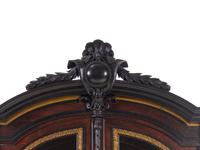 A Renaissance Revival Carved Walnut, Parcel Ebonized and Parcel Gilt Vitrine Cabinet on Stand