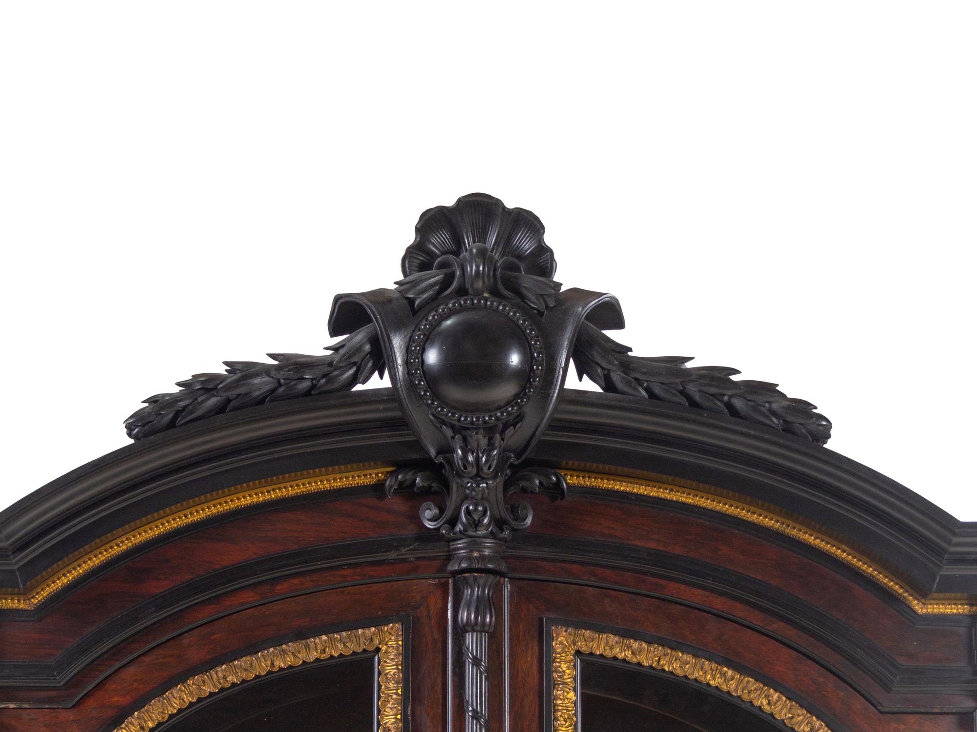 A Renaissance Revival Carved Walnut, Parcel Ebonized and Parcel Gilt Vitrine Cabinet on Stand