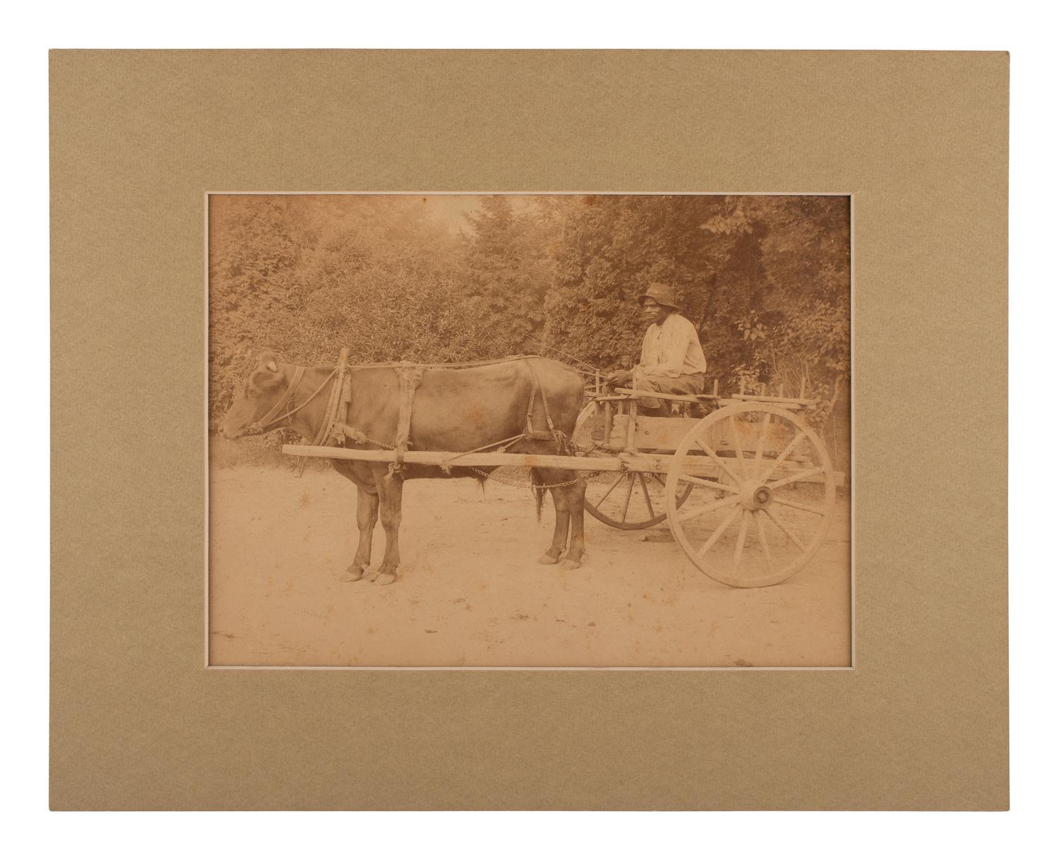 [EARLY PHOTOGRAPHY]. Photograph of an African American male subject driving a cart.