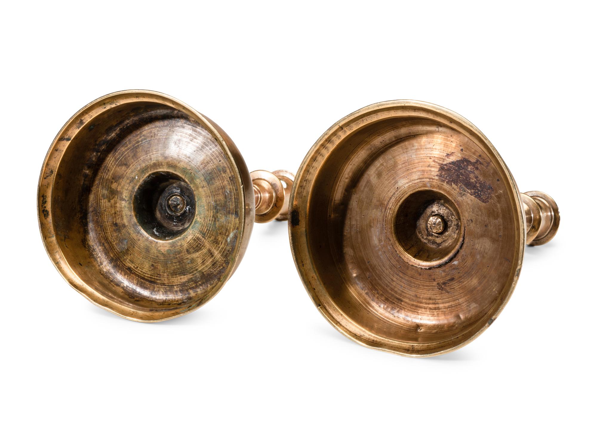 A Near Pair of Dutch William and Mary Brass Bell-Bottom Candlesticks