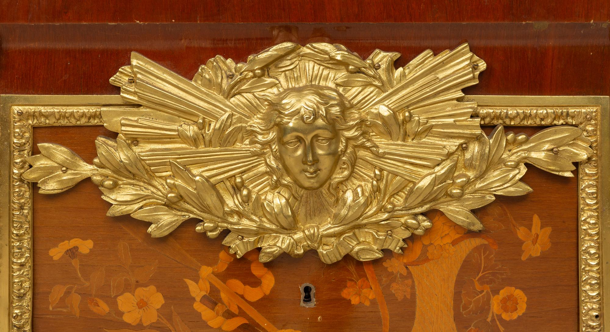 A Louis XVI Style Gilt Bronze Mounted Marquetry Commode