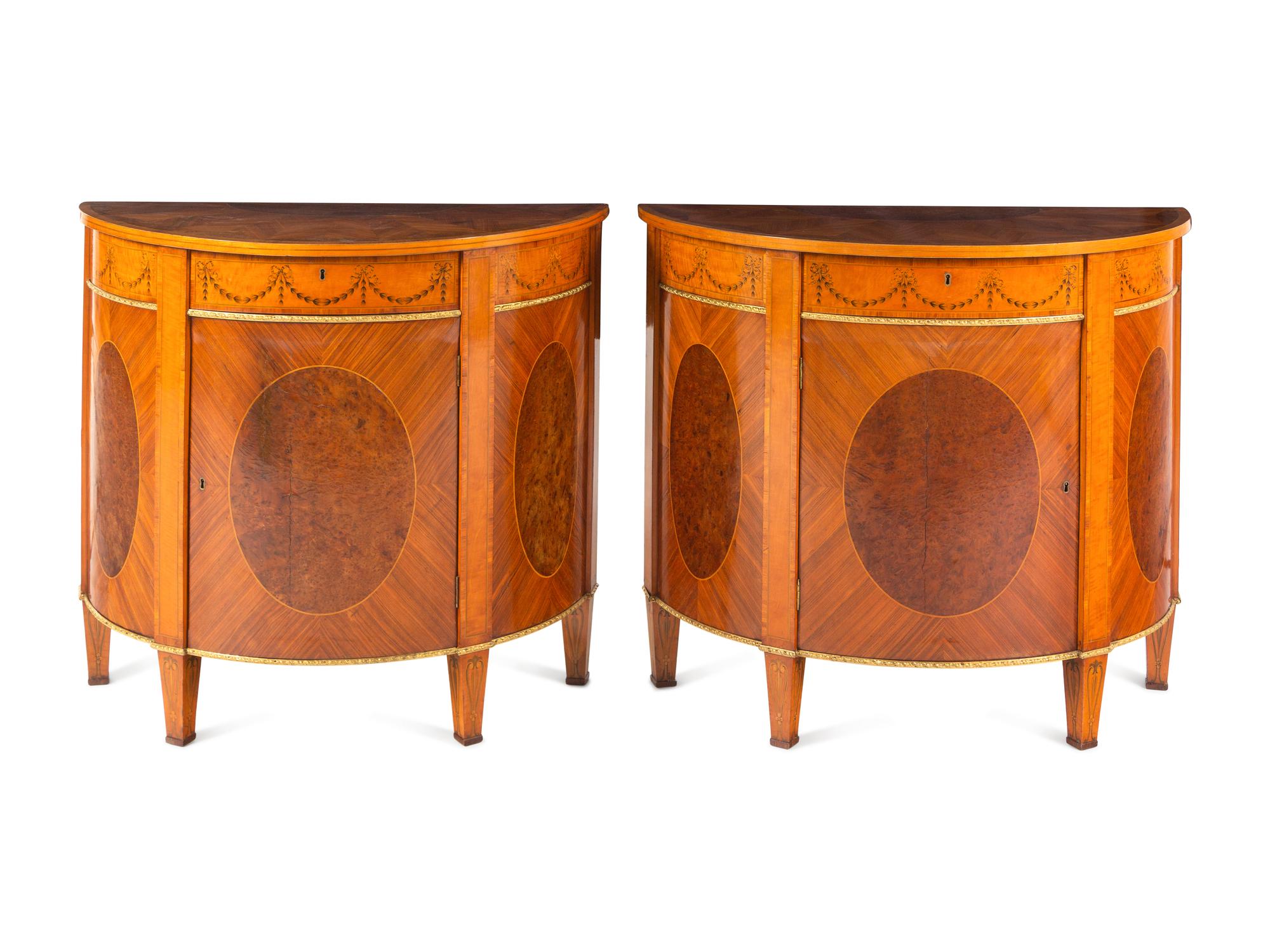 A Pair of George III Gilt Bronze Mounted Tulipwood, Burr Yew and Satinwood Marquetry Demilune Cabinets