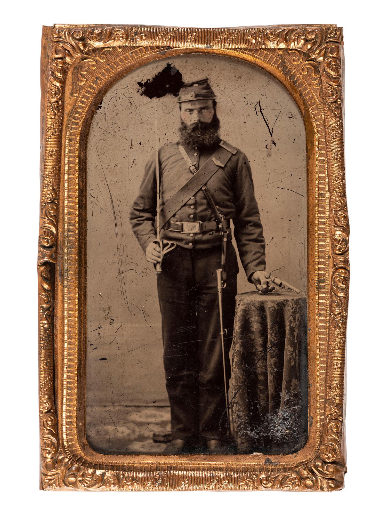 [CIVIL WAR]. CDV-sized ruby ambrotype standing portrait of a triple armed cavalryman with tentative attribution.