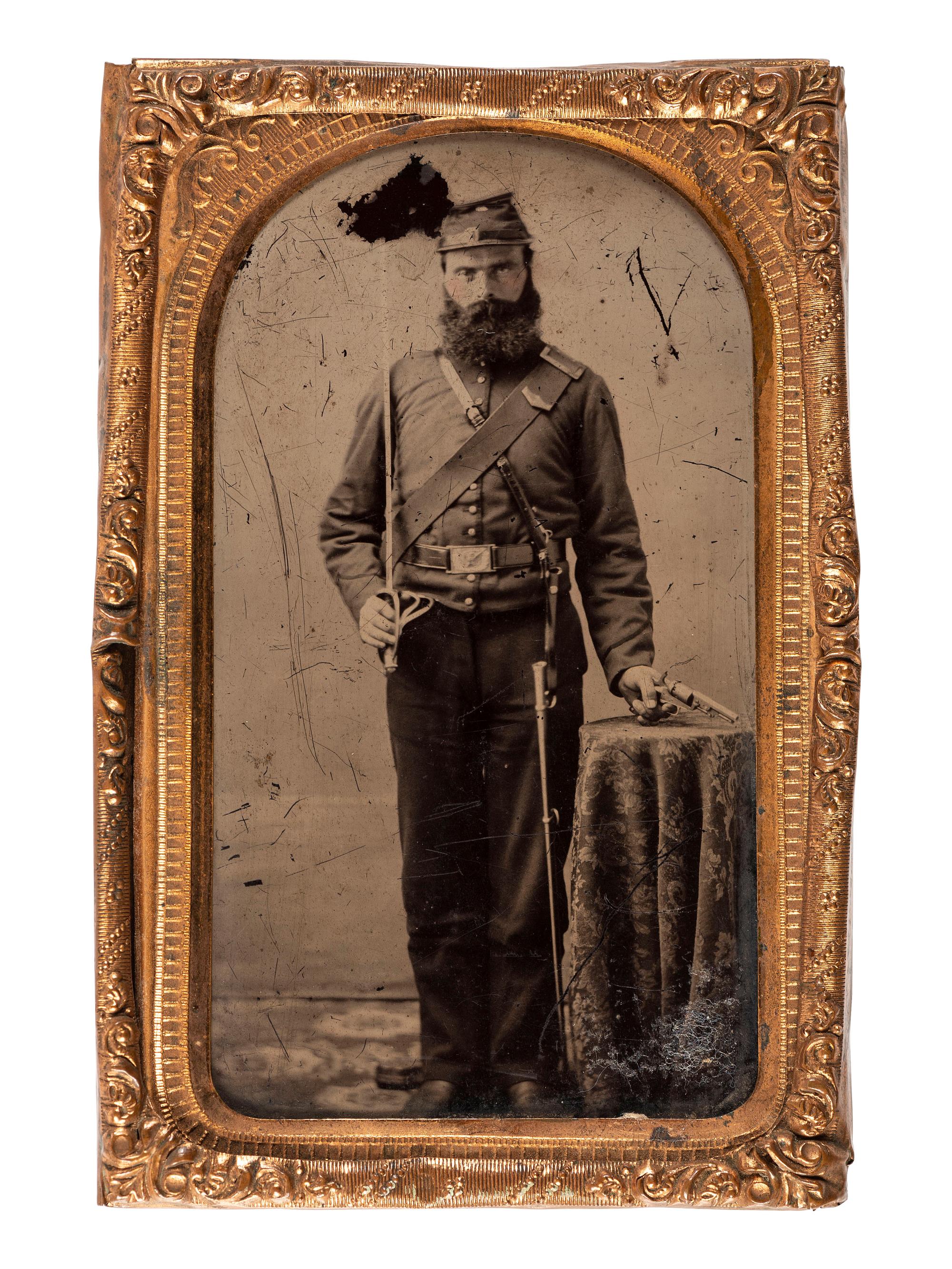 [CIVIL WAR]. CDV-sized ruby ambrotype standing portrait of a triple armed cavalryman with tentative attribution.
