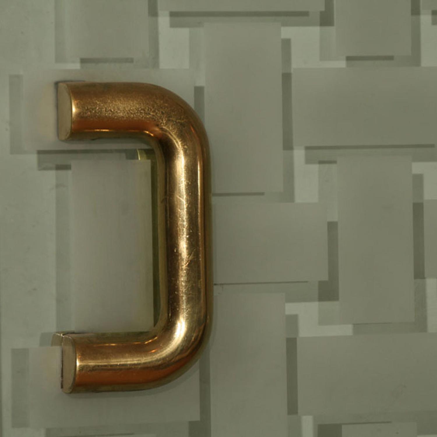 A Mid-Century Brass and Glass Entryway 72" W x 6" D x 96" H — United States, Mid-20th Century