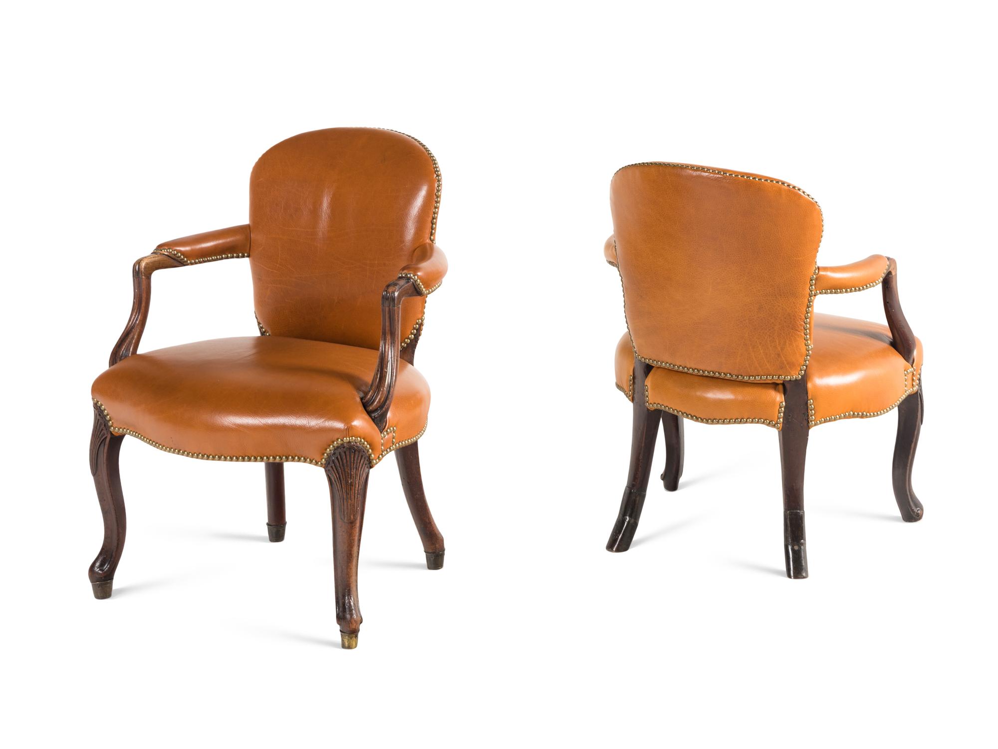 A Near Pair of George III Mahogany Leather-Upholstered Armchairs