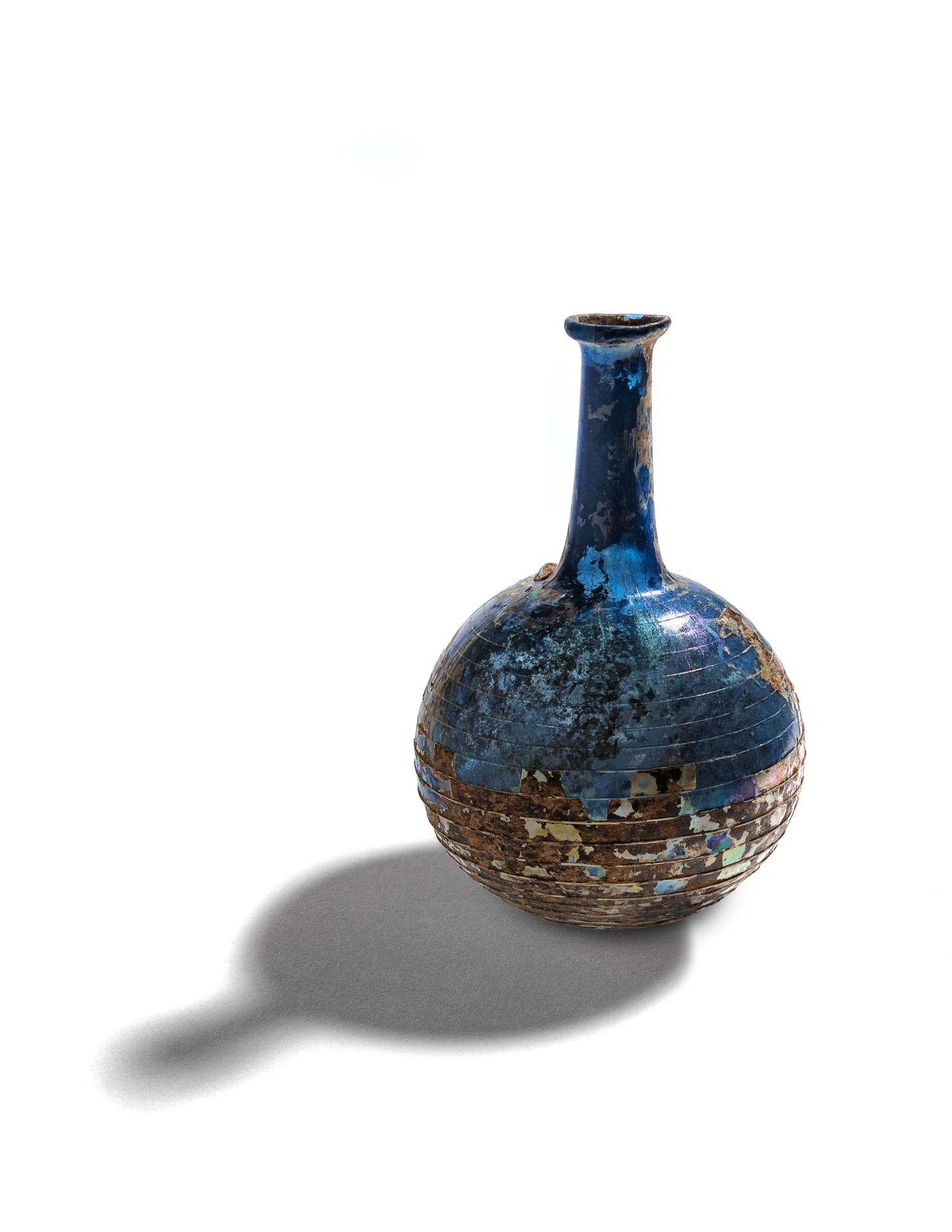 A Roman Blue Glass Bottle with Spiral Trail