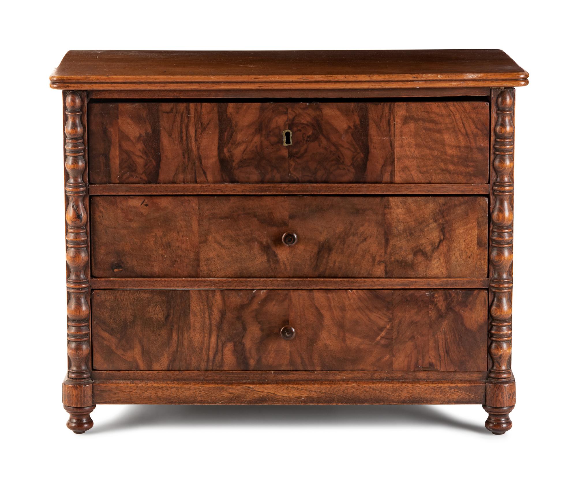 An English Diminutive Walnut Chest of Drawers