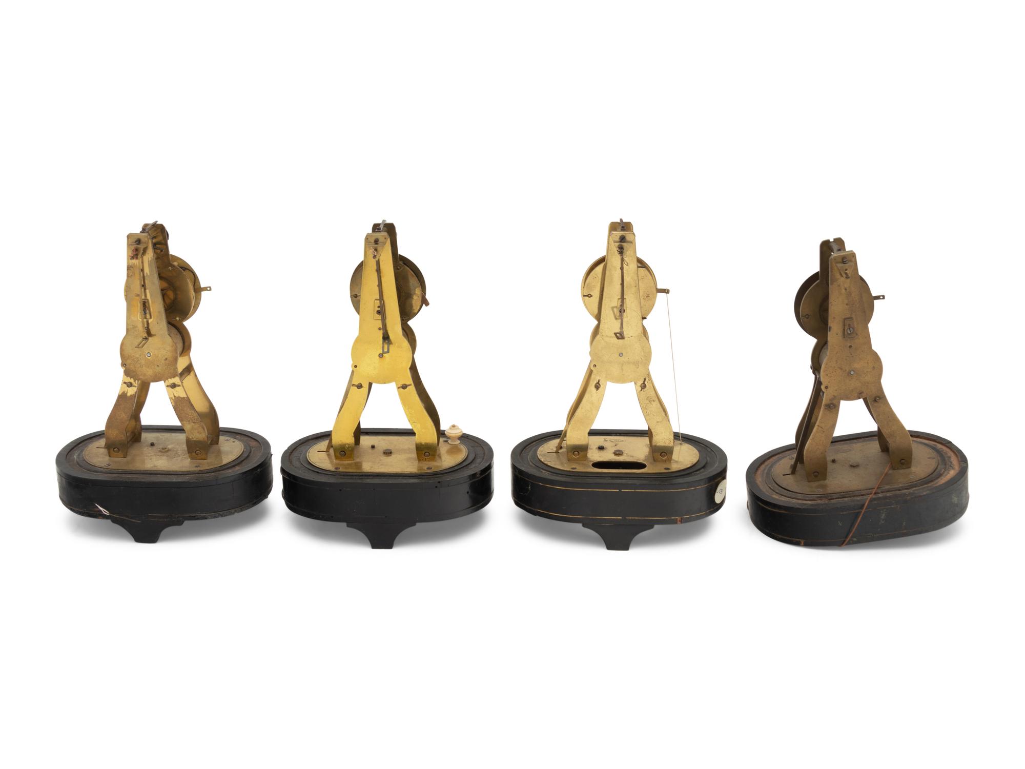 A Group of Four Brass Skeleton Clocks