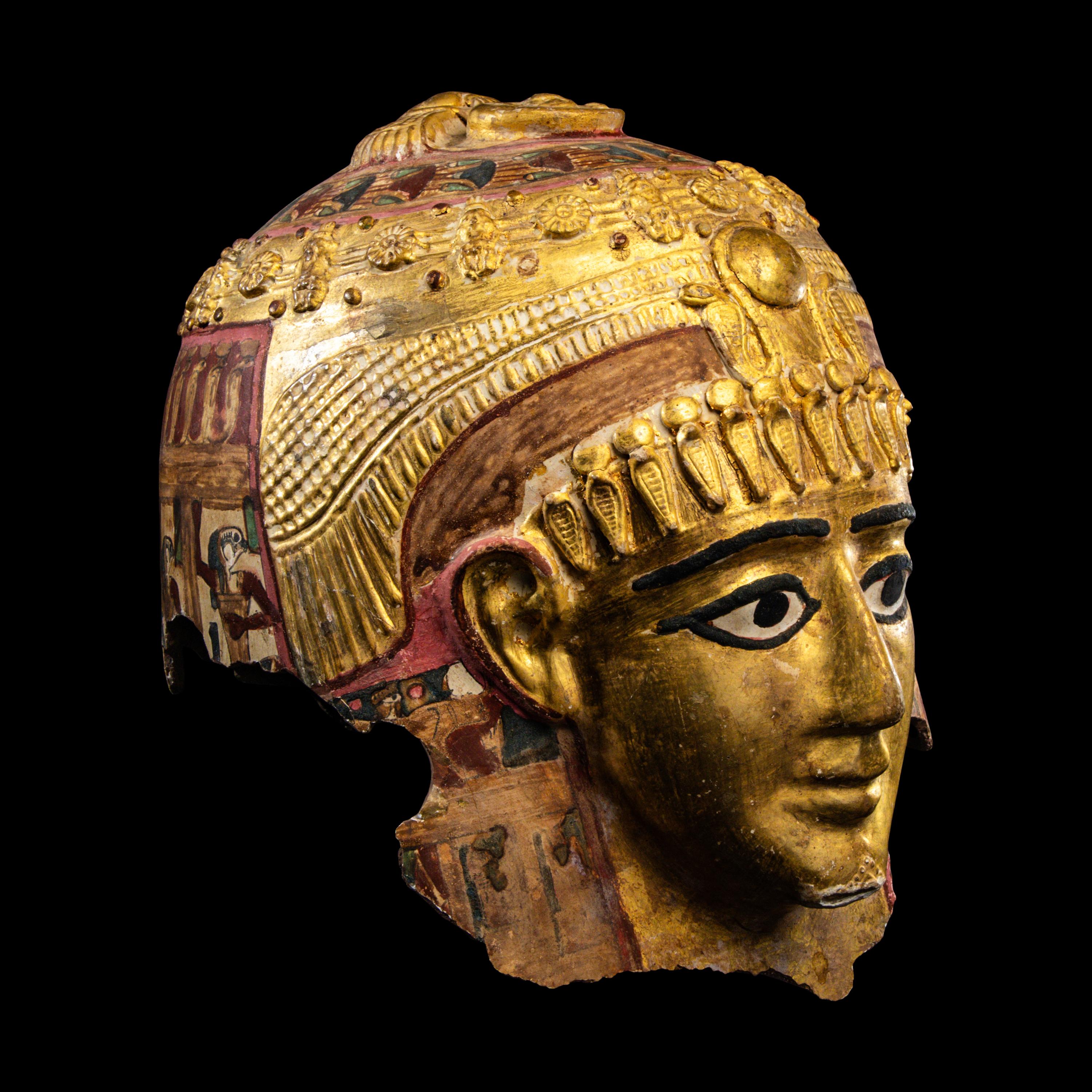 An Egyptian Gilt Cartonnage Mummy Mask of a Woman