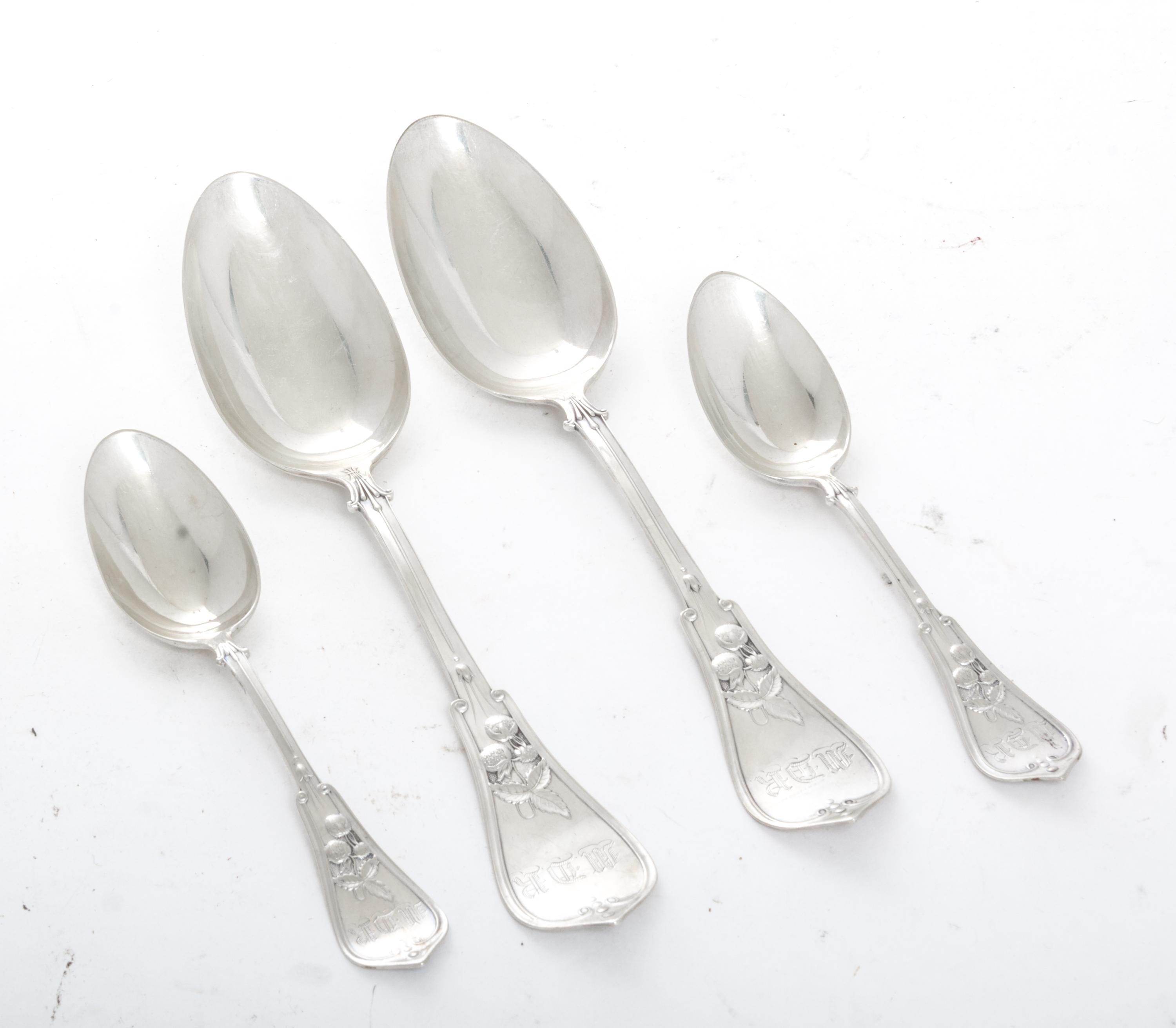 A Collection of American Coin Silver Spoons, , comprising 6 table spoons and 12 teaspoons, each with foliate and berry decorated handle