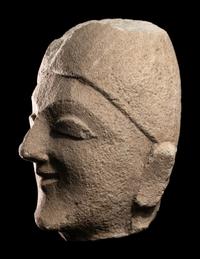 A Cypriot Limestone Head of a Man Wearing a Helmet