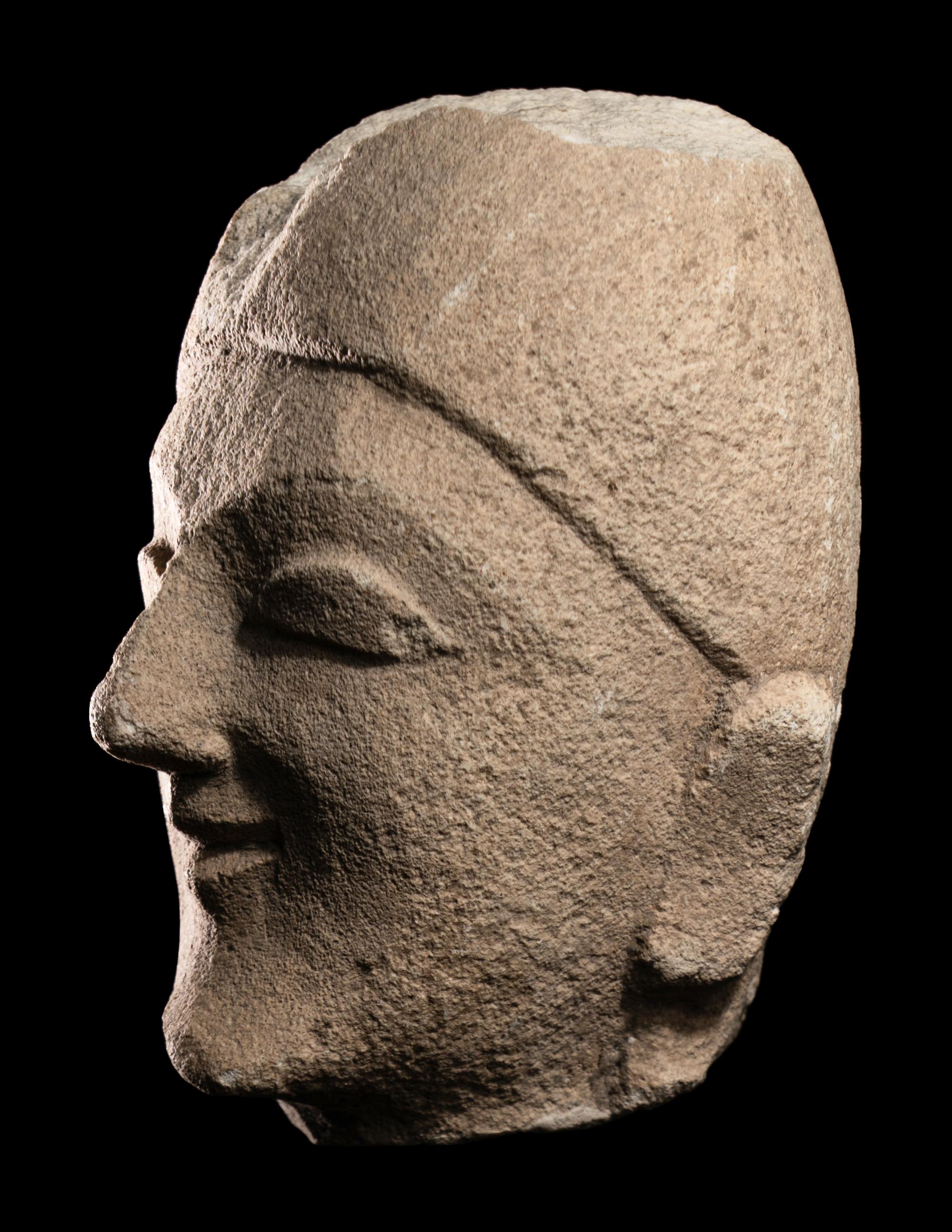 A Cypriot Limestone Head of a Man Wearing a Helmet