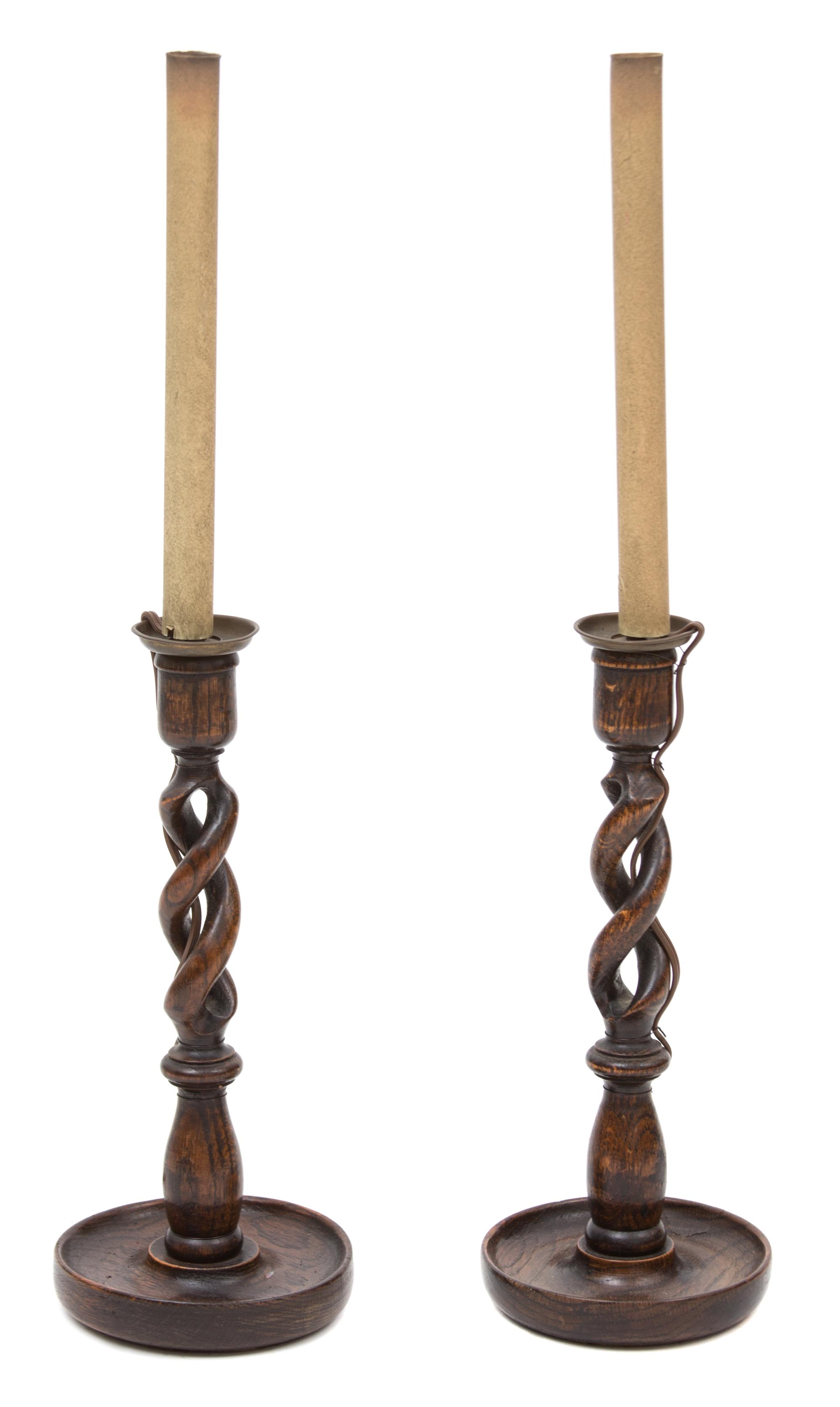 A Pair of Walnut Barley Twist Candlesticks Overall height 26 inches.
