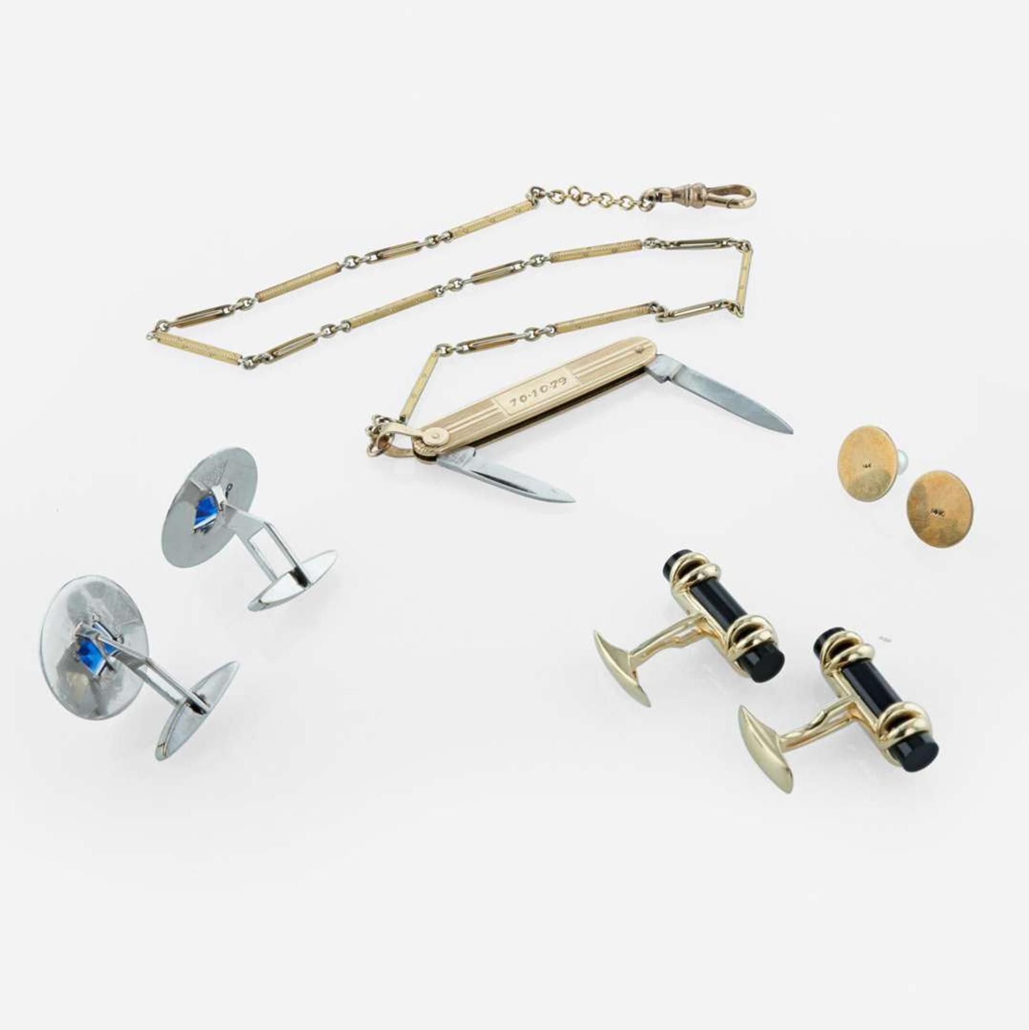 A collection of men's gold accessories